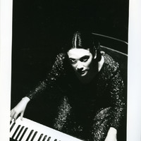 Black-and-white photograph of Natasha Lohan as 'The Musician' in Tailors Requiem by Pan Pan Theatre Company