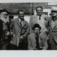 Black and white photograph of Francis Xavier Ford, John Wayne, Victor MacLagan, Barry Fitzgerald and John Ford on location for 'The Quiet Man'.