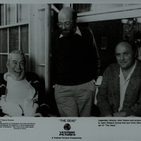 Black and white photograph showing John Huston, Wieland Schulz-Kiel and Chris Slievernich on the set of 