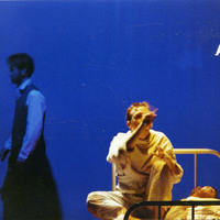 Colour photograph of three actors, of which two on a hospital bed, in The Man With Two Kisses by Pan Pan Theatre Company